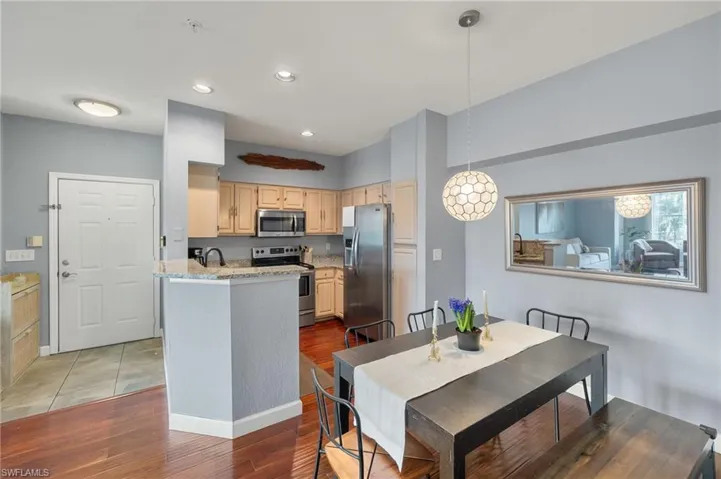Dining room featuring dark wood-style flooring and recessed lighting