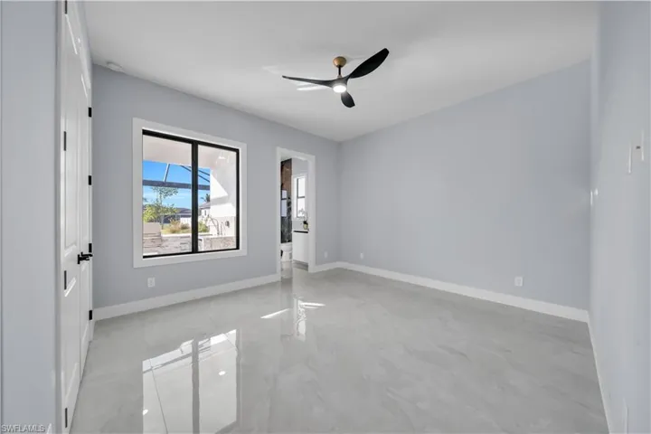 Unfurnished room with a ceiling fan and baseboards