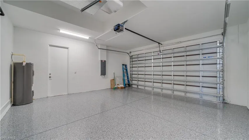 Nice garage with epoxy flooring & door to side yard.