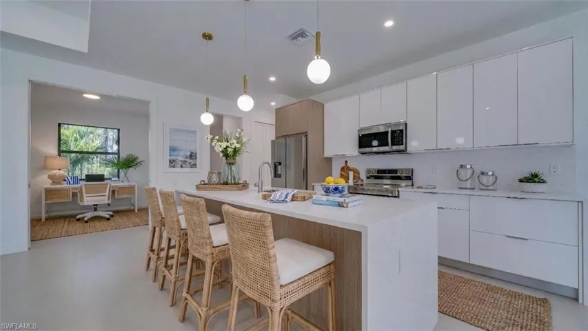 Kitchen Island showing entrance to den/office.  Virtually staged & enhanced.