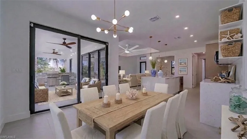 View from dining area with another set of 8' sliding doors leading to the lanai. Virtually staged & enhanced.