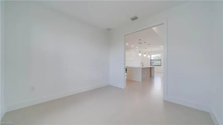 Den/Office off living area; has pocket doors. Large enough to convert to a 4th bedroom if desired.