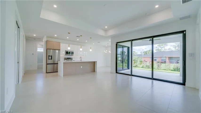 Great Room features 8' tall sliding doors, tray ceiling with recessed lighting.