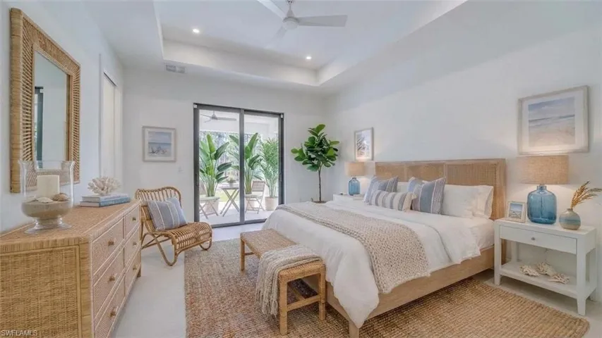 Primary suite showing access to the lanai. Virtually staged & enhanced.