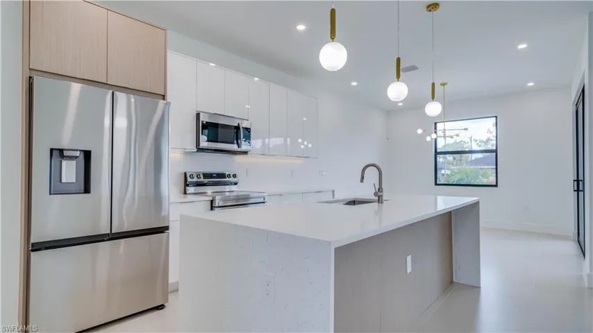 Beautiful quartz countertops, oversized waterfall Island.