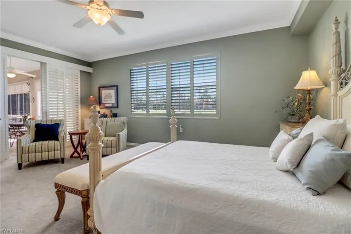 Bedroom with multiple windows, crown molding, carpet floors, and ceiling fan