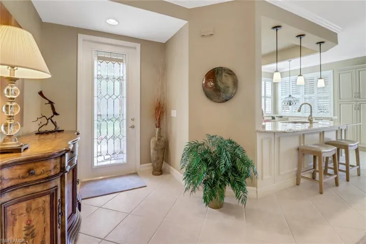 Tiled foyer with sink