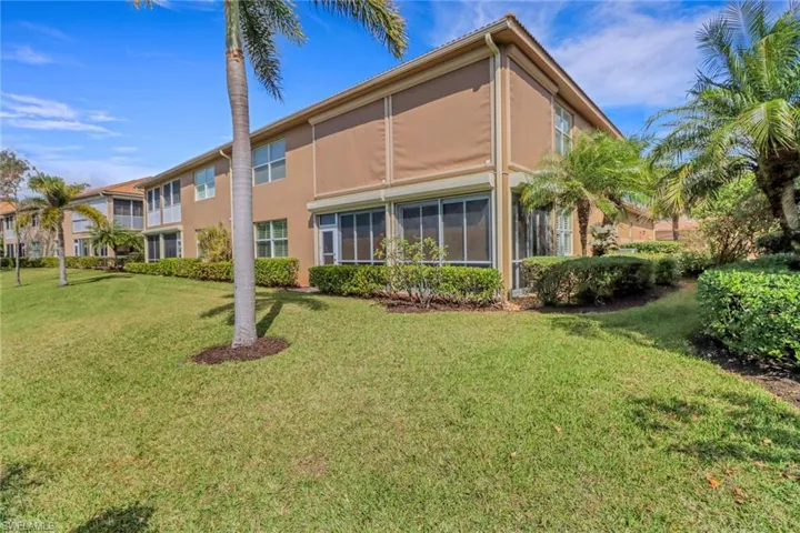 Back of property with a lawn