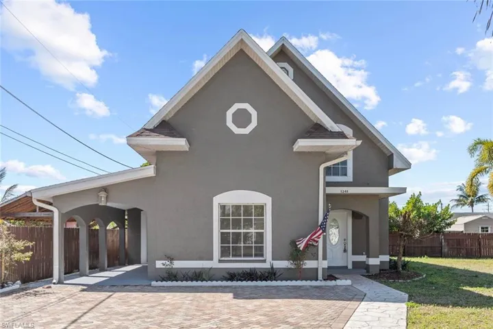 Traditional home featuring stucco siding