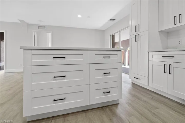Detailed view of wood finished floors and recessed lighting