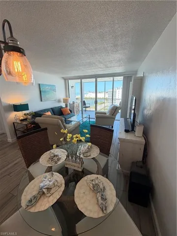 Dining room with wood finished floors and a textured ceiling