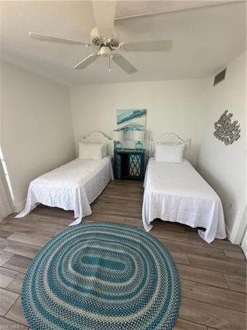Bedroom featuring wood finished floors and ceiling fan