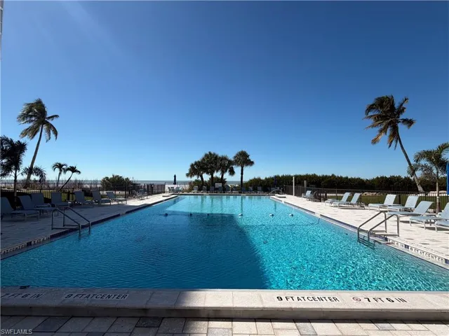 Community pool with a patio