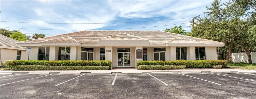 View of property with uncovered parking