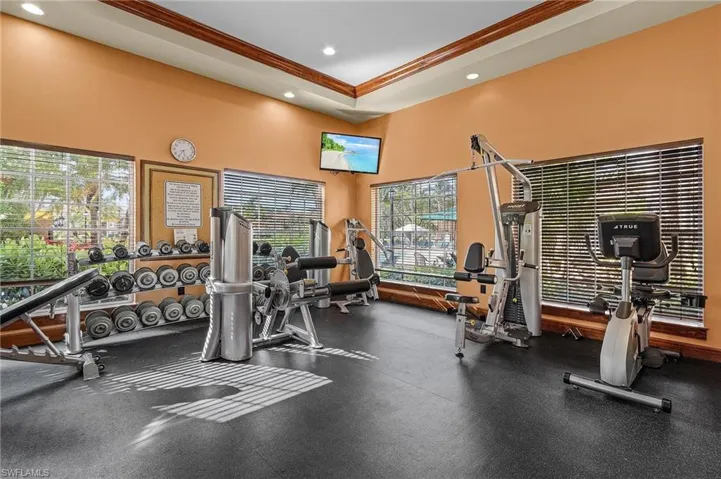 Workout area with recessed lighting and crown molding