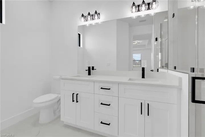 Spare room with baseboards and a raised ceiling