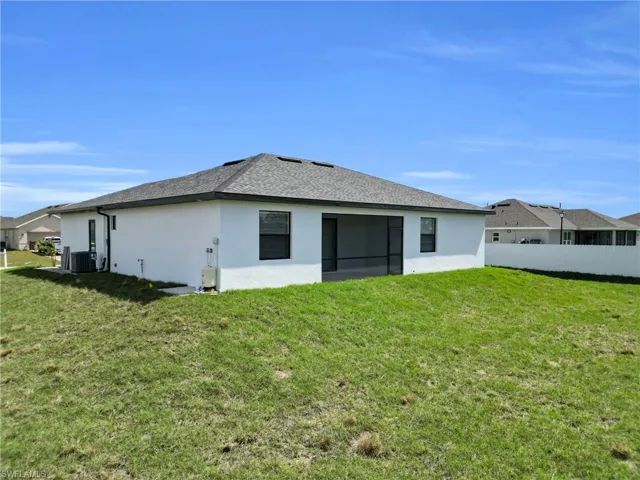 Back of property featuring stucco siding