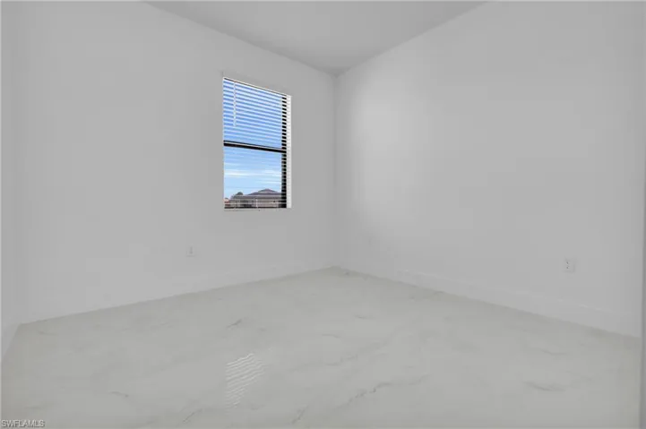 Bathroom with double vanity and a marble finish shower