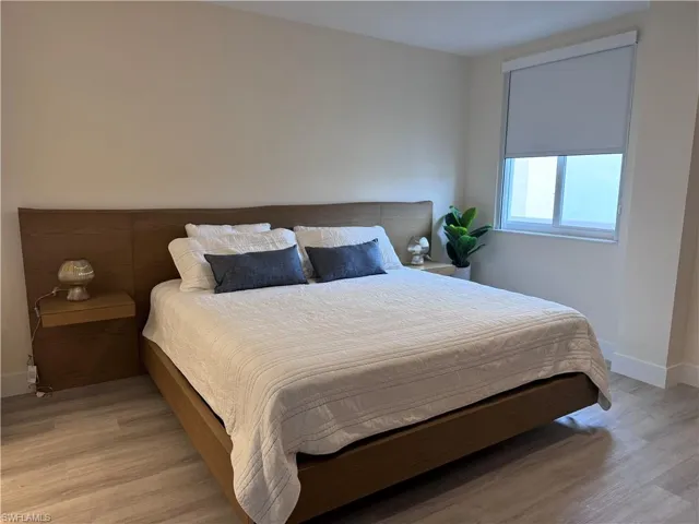 Bedroom with light hardwood / wood-style floors
