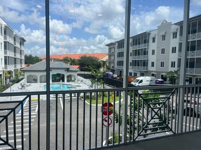 Balcony with view of pool and a sunroom