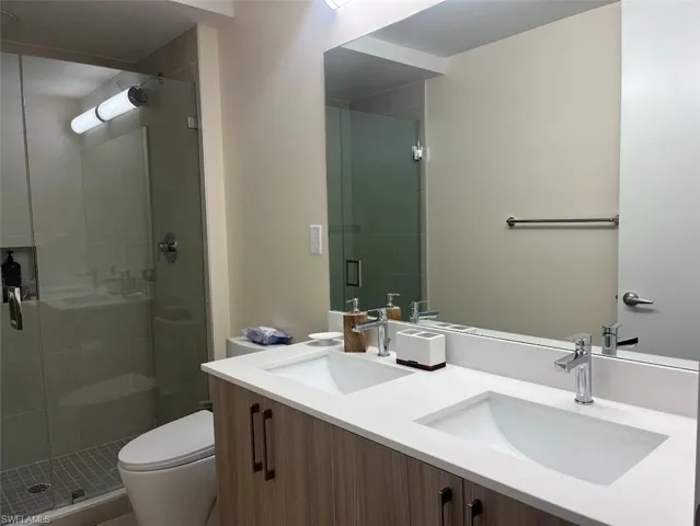Bathroom with a stall shower and double vanity