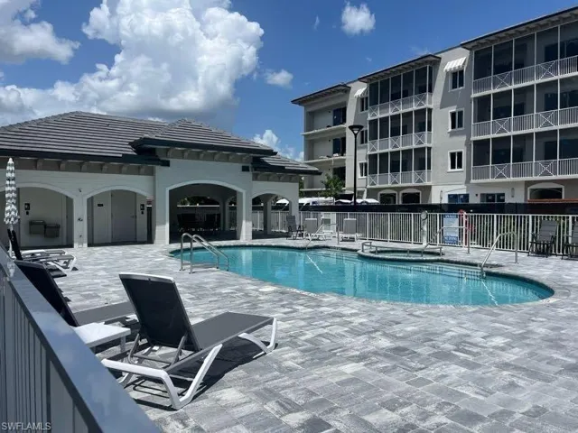 Community pool featuring a patio area and a community hot tub