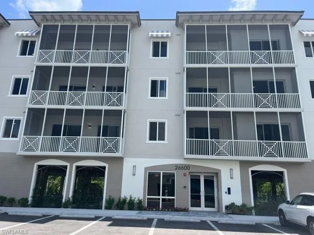 View of apartment building / complex with uncovered parking