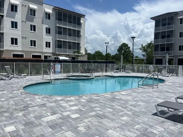 Community pool featuring a patio