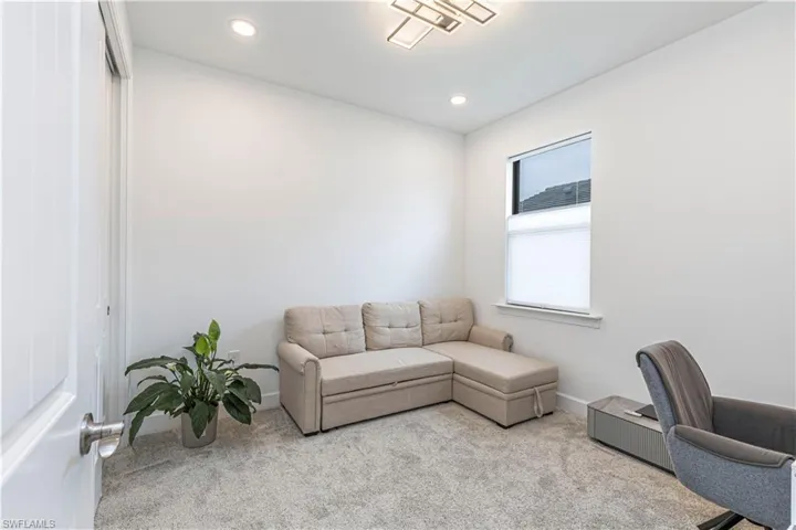 Carpeted office with recessed lighting and baseboards