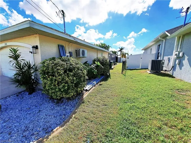 View of yard featuring central AC and a garage