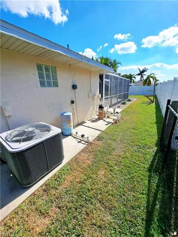 View of yard with central AC unit and a sunroom