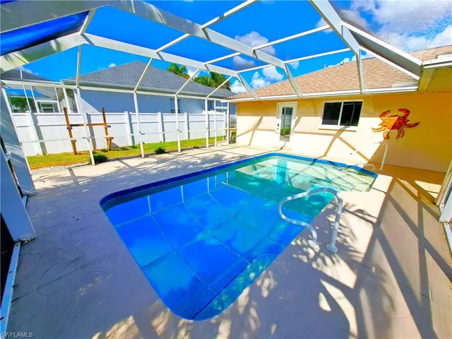 View of swimming pool with a lanai and a patio