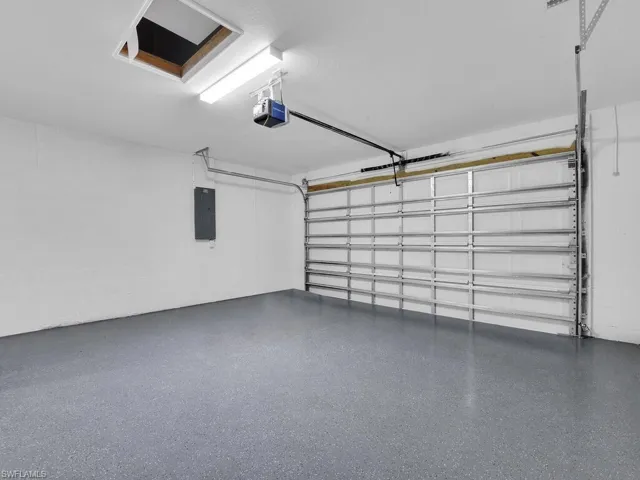Garage with a garage door opener and electric panel