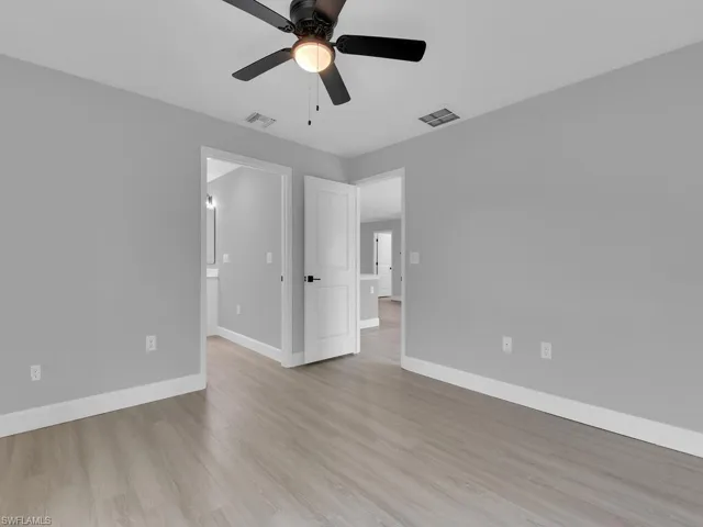 Spare room with ceiling fan and light wood-type flooring