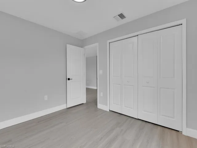 Unfurnished bedroom with light hardwood / wood-style floors and a closet