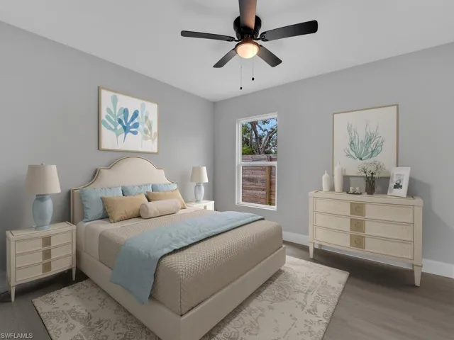 Bedroom with ceiling fan and hardwood / wood-style floors