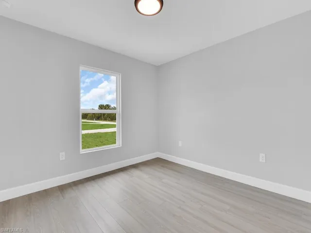 Unfurnished room featuring light wood-type flooring