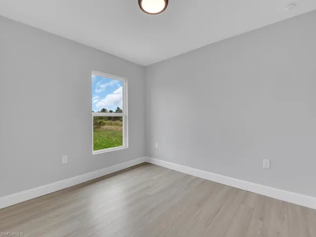 Empty room with light hardwood / wood-style flooring