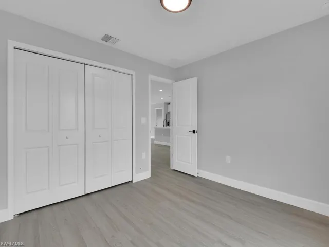 Unfurnished bedroom featuring light hardwood / wood-style flooring and a closet