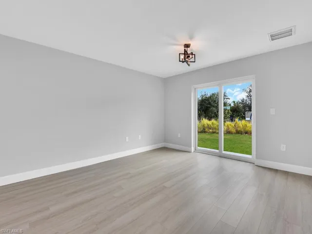 Unfurnished room with light hardwood / wood-style flooring