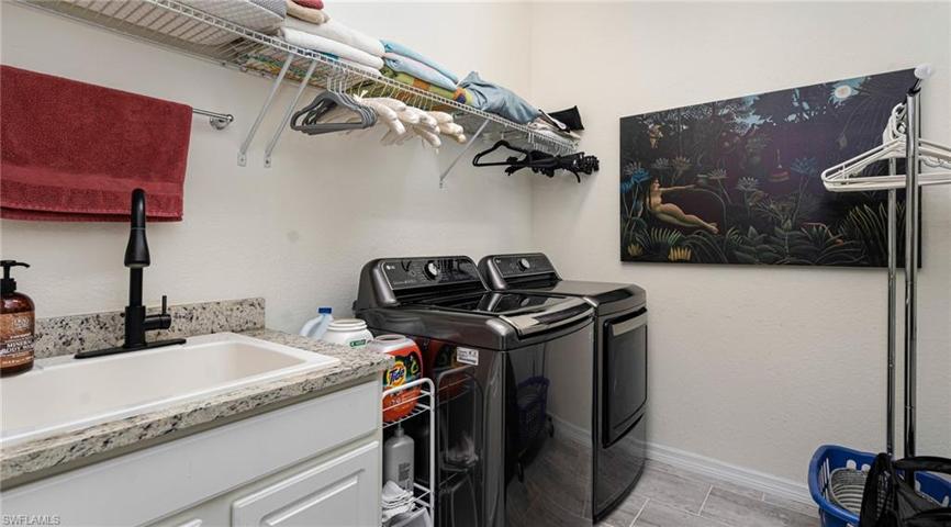 Laundry with utility sink and LG washer and dryer in black stainless steel
