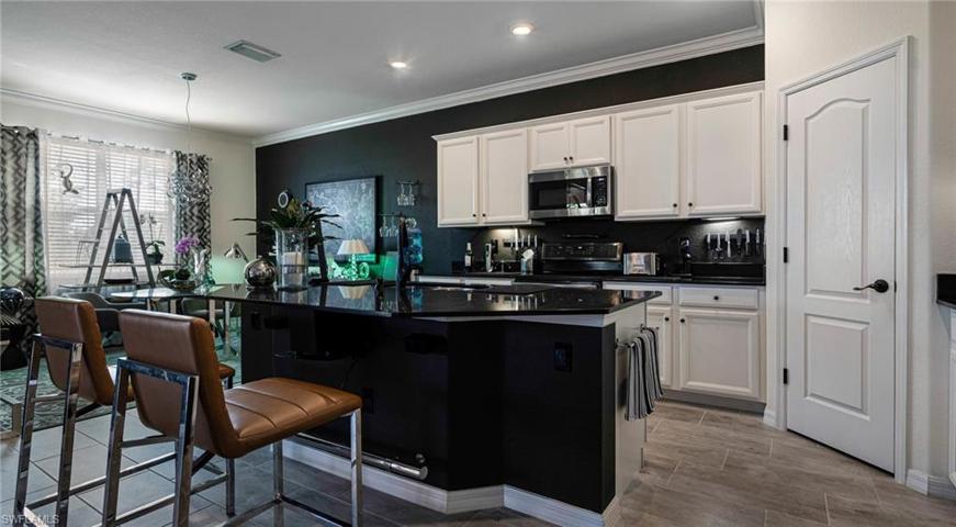Black granite island and walk in pantry