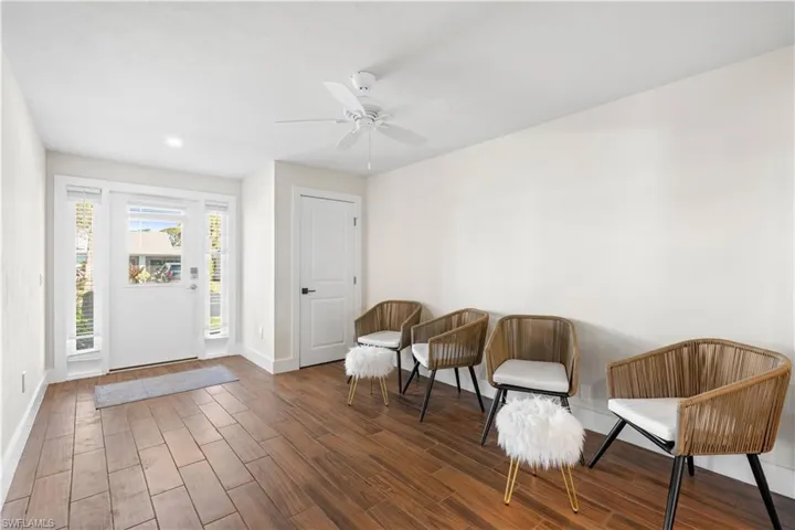 Sitting room featuring dark hardwood / wood-style floors and ceiling fan