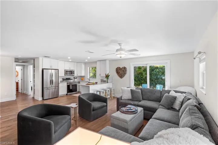 Living room featuring sink, ceiling fan, and light wood-type flooring