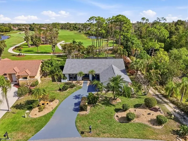Property entrance with a garage, stucco siding, and a shingled roof