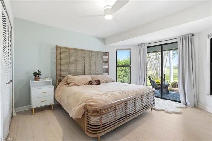 Bedroom with light wood-type flooring, a ceiling fan, and a closet