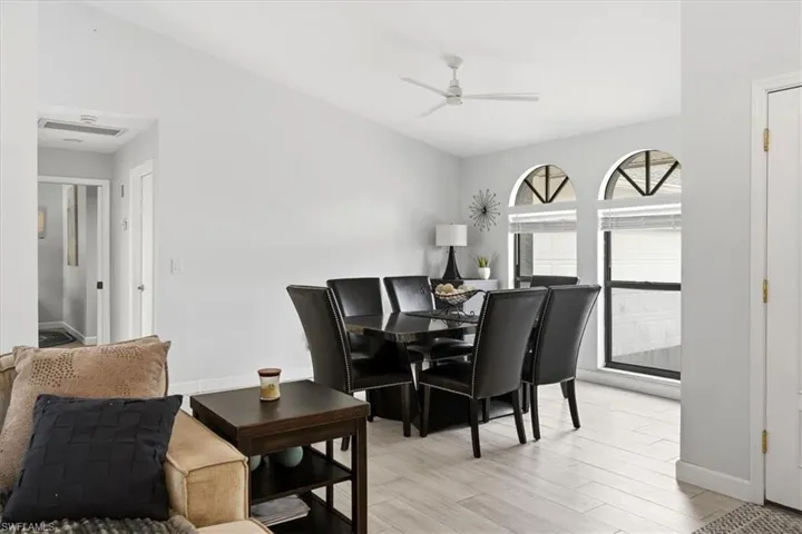 Living room with a ceiling fan, light wood-style floors, vaulted ceiling, and recessed lighting