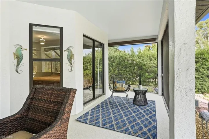 Outdoor pool with a sunroom, a patio area, a lanai, and a lawn
