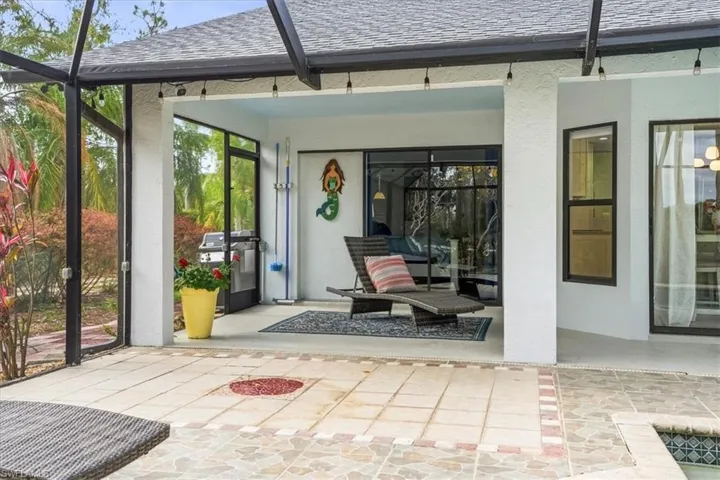 Swimming pool with glass enclosure, a sunroom, and a patio area
