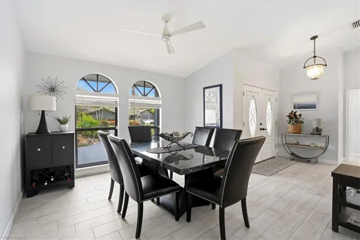 Living area featuring vaulted ceiling, wood finish floors, recessed lighting, and a ceiling fan